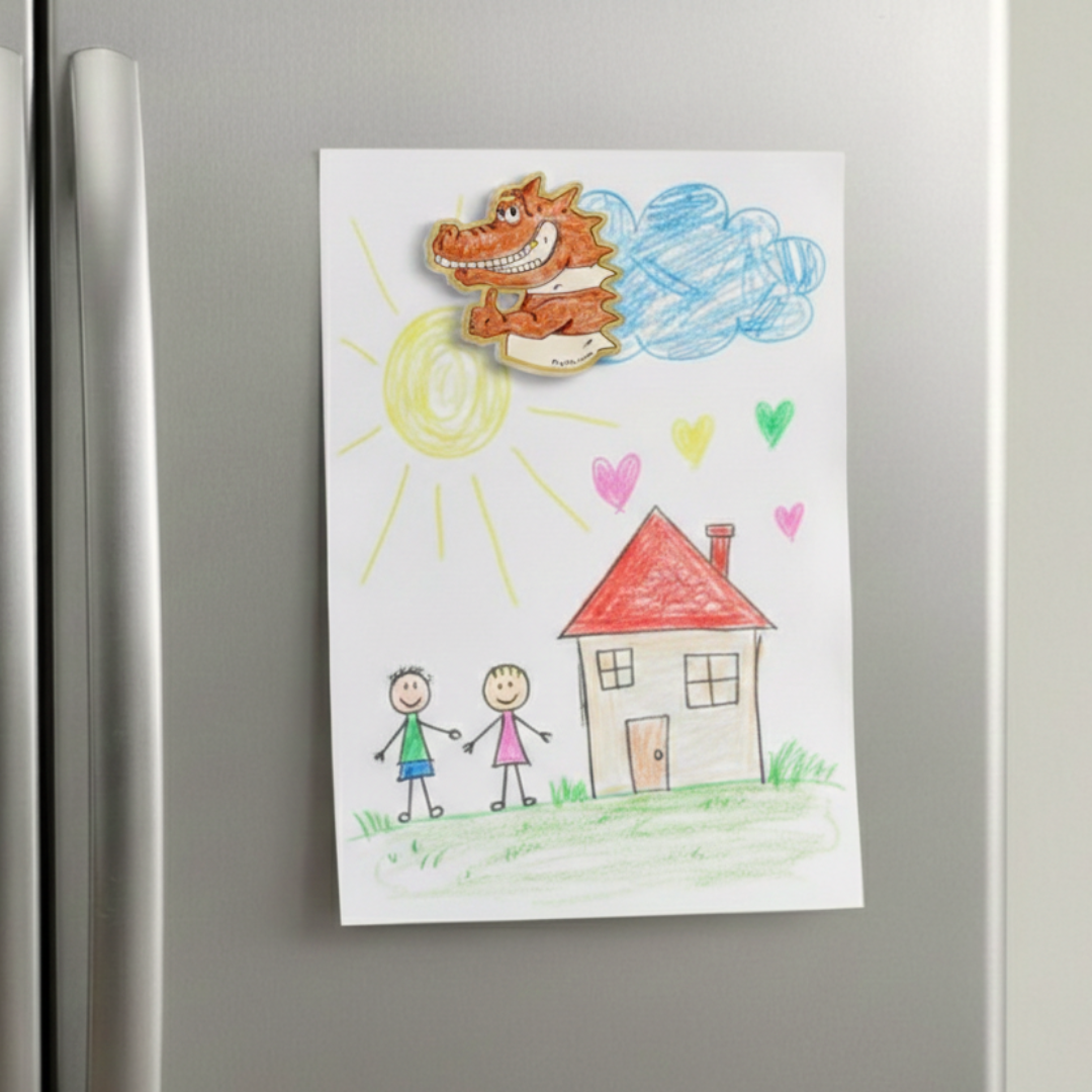 Colorful drawing of a house, two children, and a crocodile on a refrigerator. An acrylic magnet inspired by the Prpl Up Pup world.