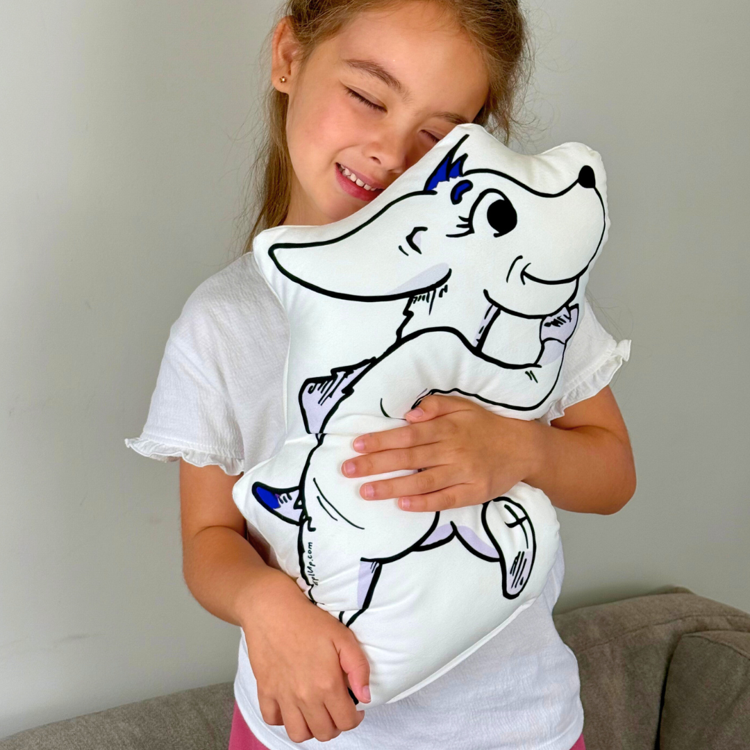 Child holding a pillow with a cartoon dog character on a plain background