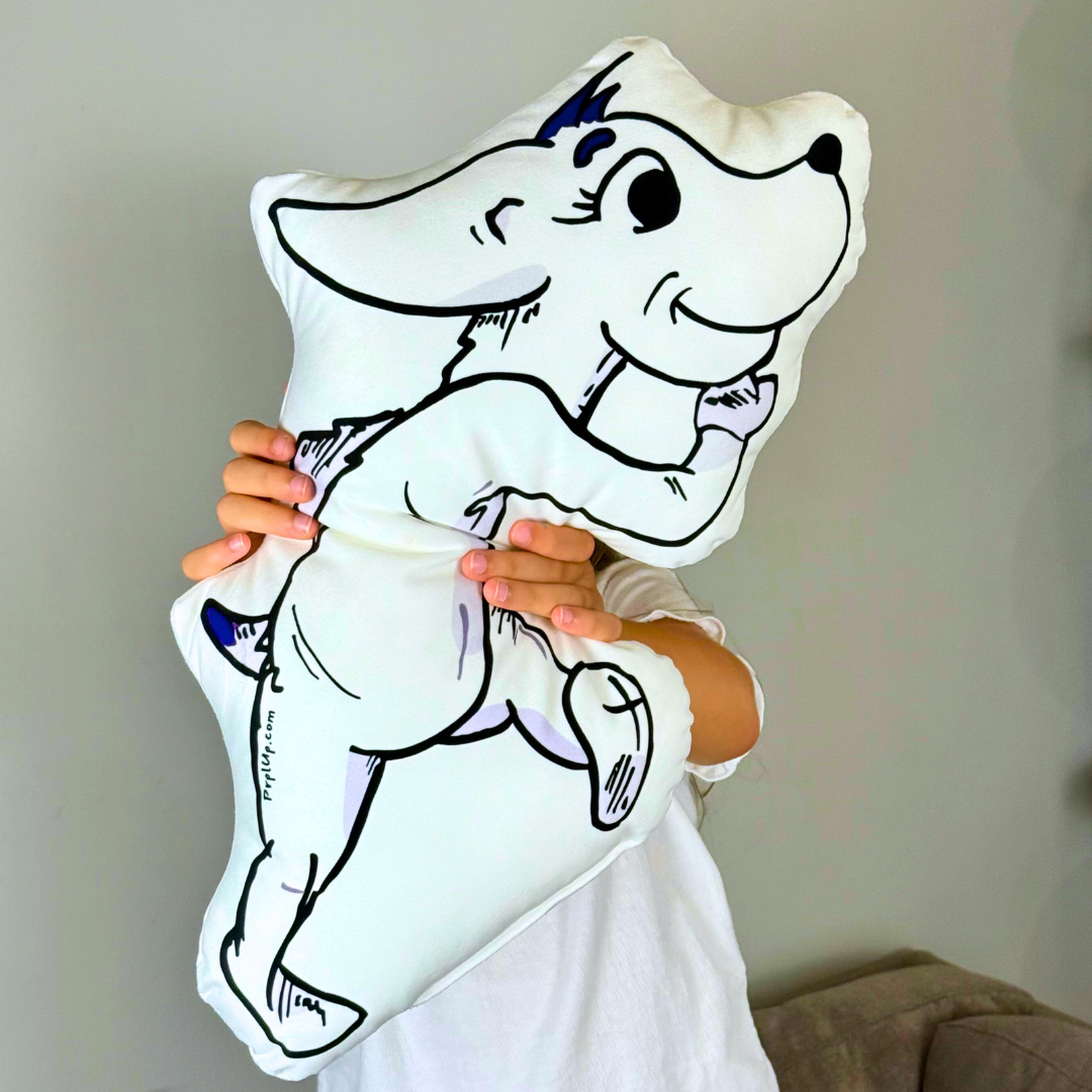 Child holding a white pillow with a black outline of a cartoon dog design.