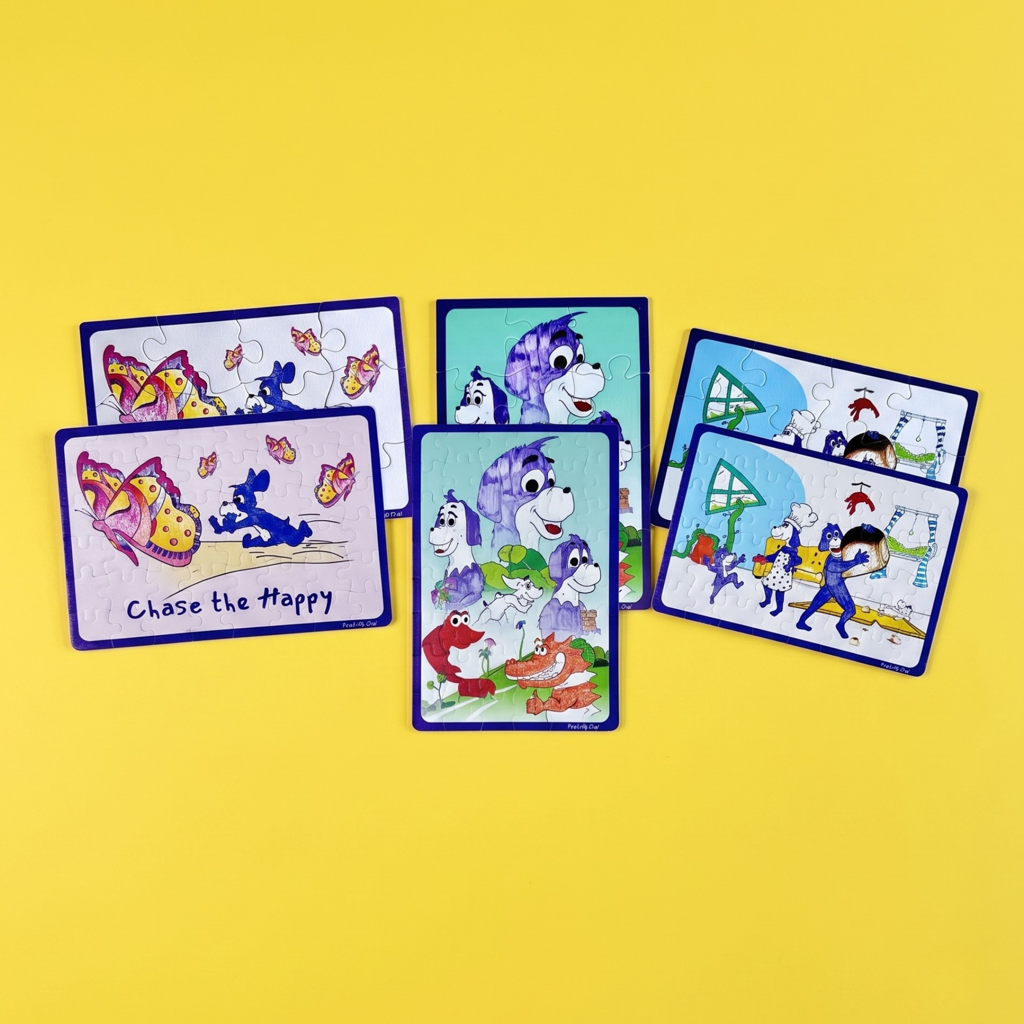 A set of colorful illustrated puzzles arranged on a bright yellow background. The puzzles feature cartoon animals and scenes, including butterflies, a purple dog, a red lobster, and characters from the world of Prpl Up Pup.