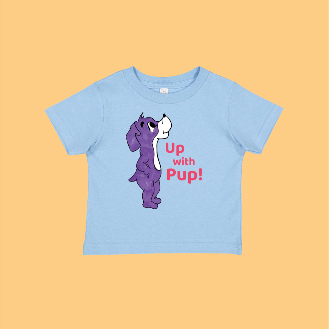 Light blue t-shirt with a purple dog graphic and 'Up with Pup!' text on a light orange background. This is Prpl Up Pup cartoon character from Up, Up, Pup! picture book.