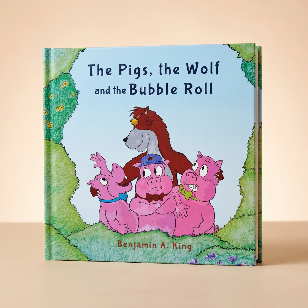 A hardcover children's book titled "The Pigs, the Wolf and the Bubble Roll" by Benjamin A. King, standing upright on a beige surface against a warm beige background. The second Prpl Up Pup Tail written and illustrated by Benjamin A. King.