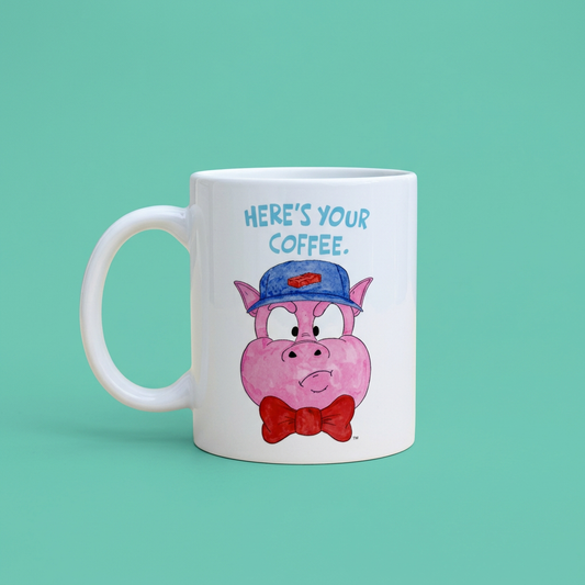 White Pig 1 mug with Here's Your Coffee artwork on a teal background